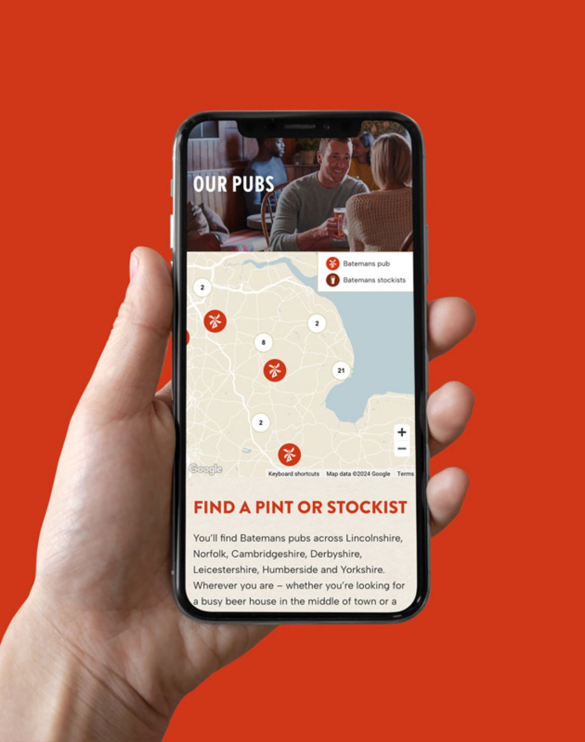 A hand holding a phone showing the find a pint functionality on the Batemans Brewery website