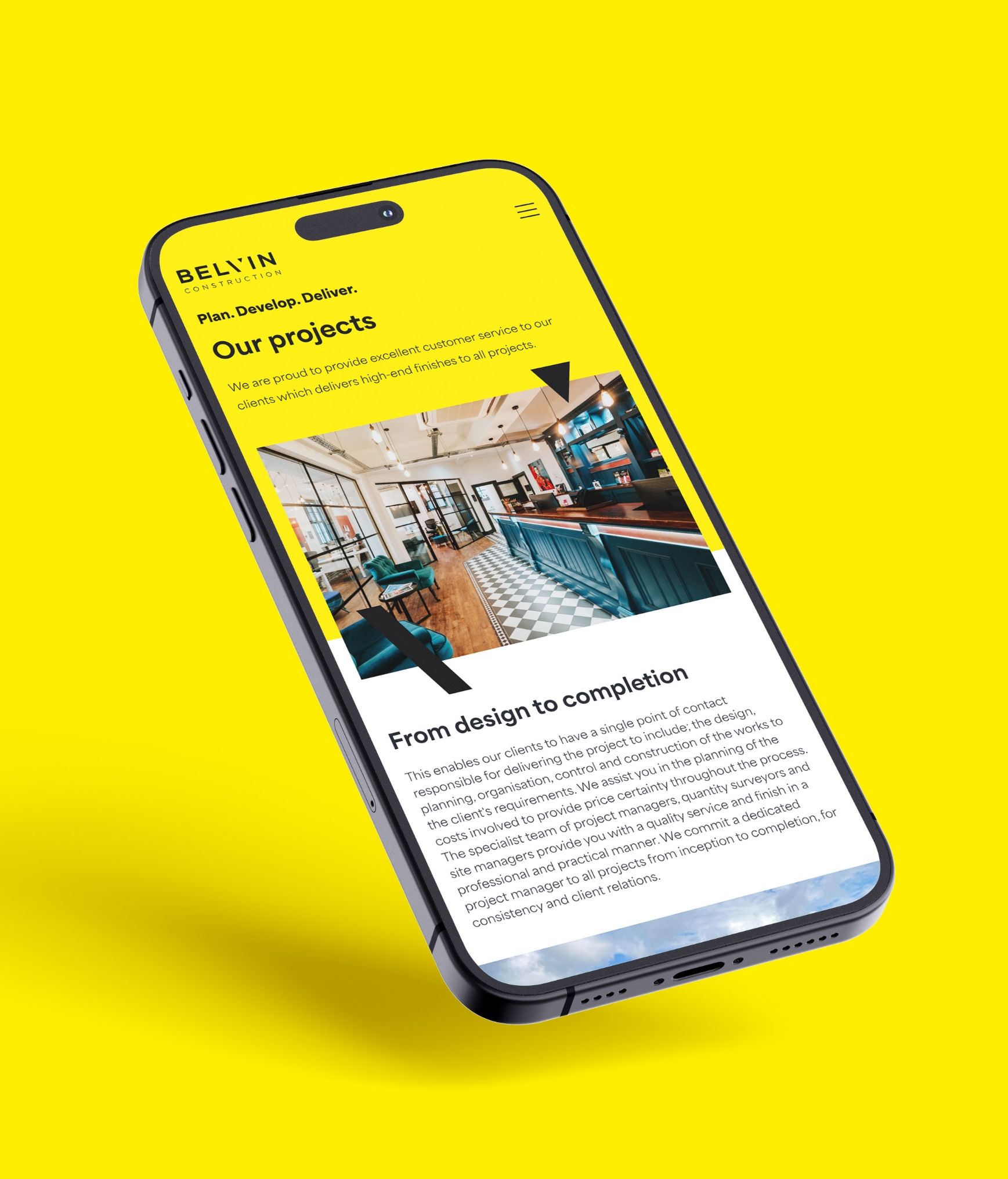 Belvin Construction website being shown on a mobile device on a yellow background